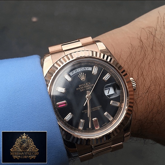 the rolex daydate with the diamond detail on his wrist