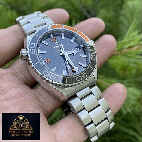 Omega Seamaster Black Dial Oyster Bracelet Replica on the hand & grass background