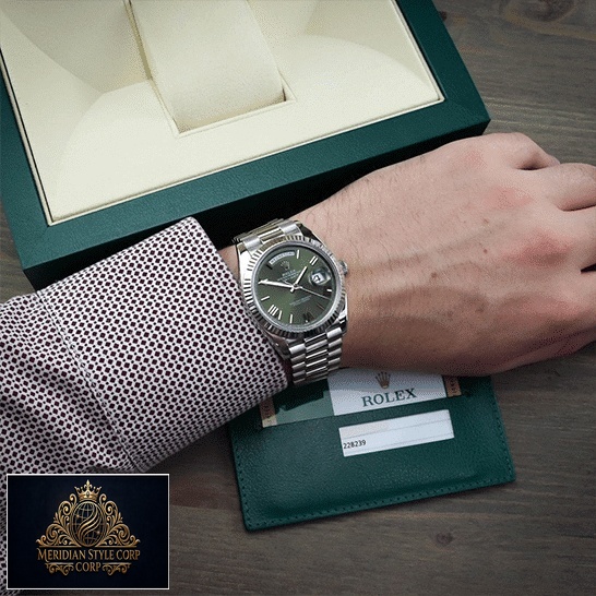 Rolex Day-Date Olive Green 228239 Replica Rolex Box in front of on is arm