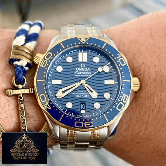 Omega Seamaster Diver 300m Gold Blue Dial Replica on the man wrist