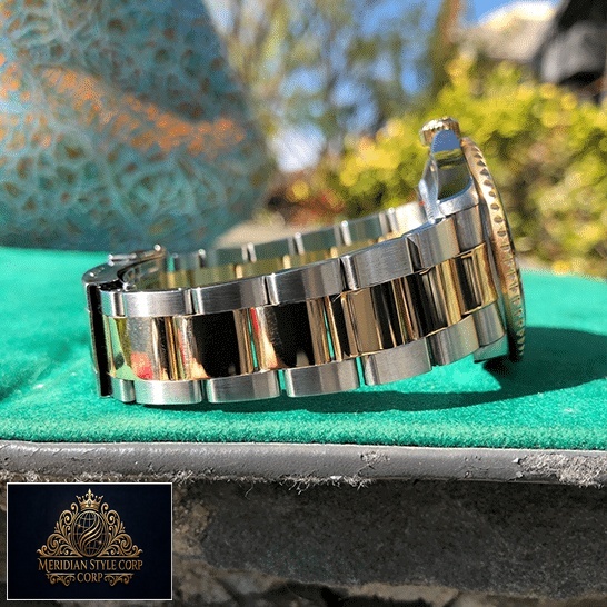 Rolex Submariner 16613 Serti Two Tone Stainless Steel Gold Diamond Replica on the table