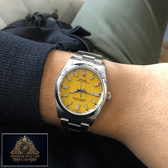 Rolex Perpetual 124300 Yellow Dial Stick indices Replica on his arm