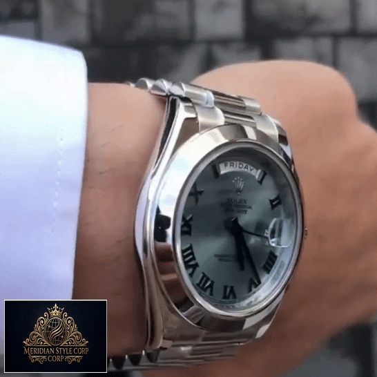 the man has a Rolex Day-Date II Stainless Steel Ice Blue Roman Dial 218206 Replica