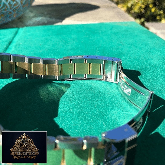 Rolex Submariner 16613 Two Tone Stainless Steel Gold Diamond Replica on the table